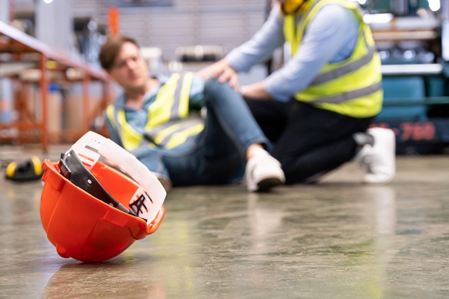An employee lays on the ground after having fallen at work